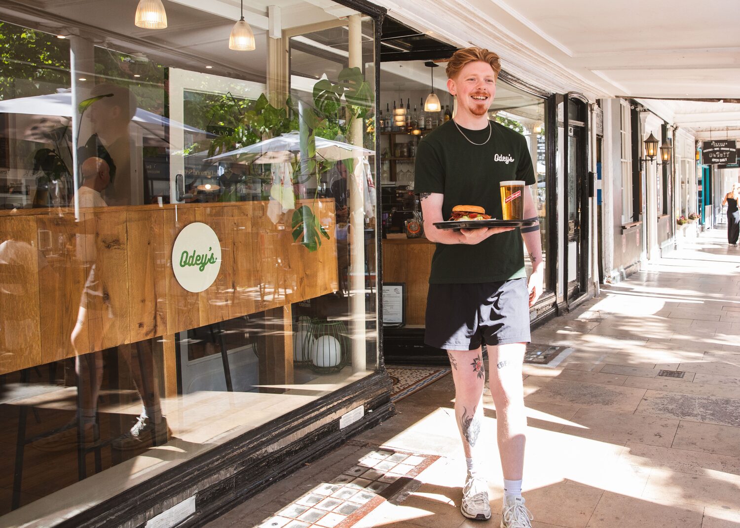 Bringing an order out to the colonnade at Odey's on The Pantiles